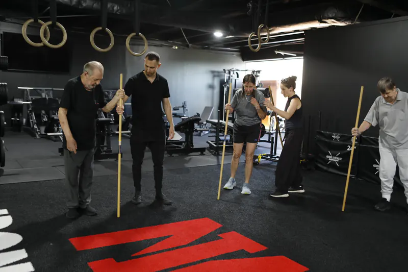 Silver Monk group class with dowel rods at Iron Monk