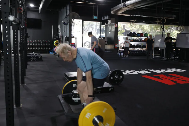 Senior man deadlifting at Iron Monk Fitness